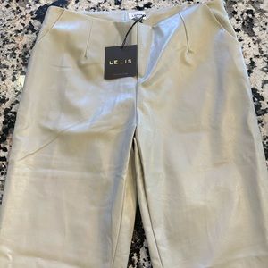 Cream faux leather pants with front slit size large. Brand new with tags.